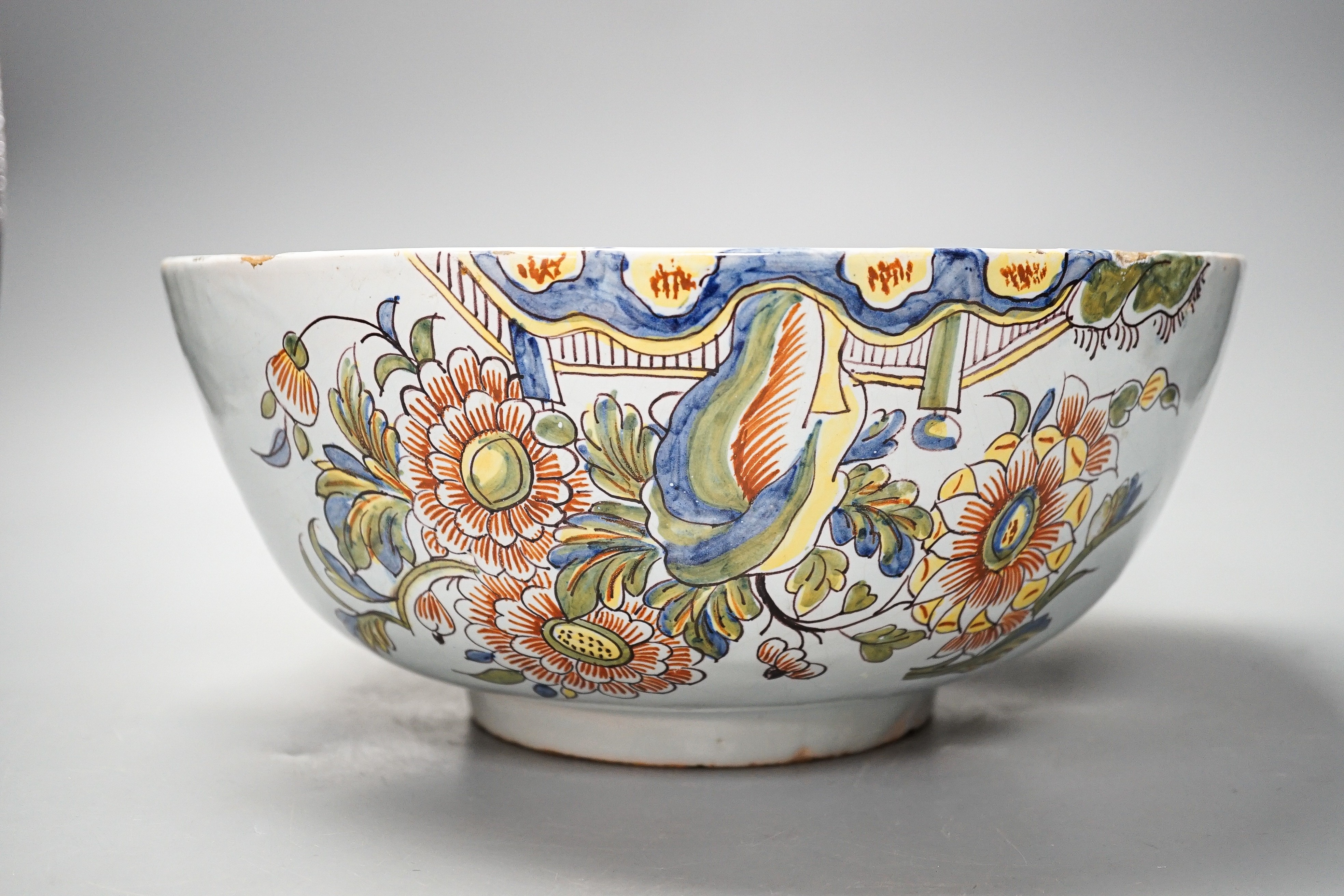 Lord Admiral Nelson. A commemorative Delftware punch bowl, 19th century, painted in polychrome with a portrait of Nelson, as hip and floral sprays, D. 30cm, splinter chip to edge